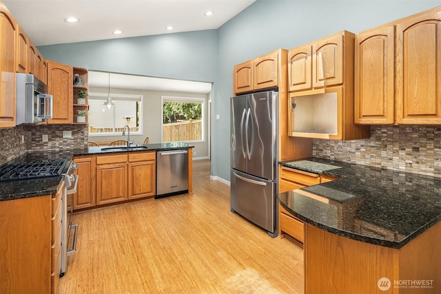 23018 NE 25th Way, Sammamish, WA 98074 - kitchen with stainless steel appliances, a sink, light wood-style floors, a peninsula, and decorative backsplash