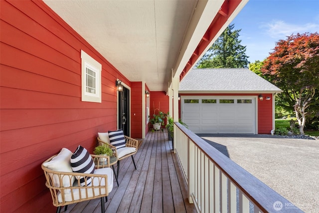 8277 New Holland Ct, Bainbridge Island, WA 98110 - deck featuring a garage and asphalt driveway