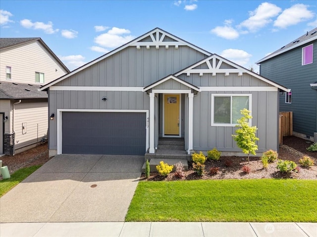 4413 NE 182nd St Unit 111, Vancouver, WA 98686 - view of front of house featuring board and batten siding, an attached garage, driveway, and a front yard