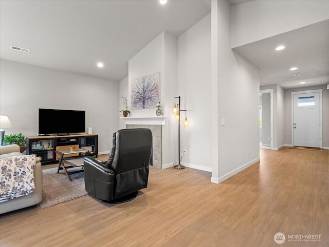4413 NE 182nd St Unit 111, Vancouver, WA 98686 - living area with light wood-style flooring, high vaulted ceiling, baseboards, recessed lighting, and a tile fireplace