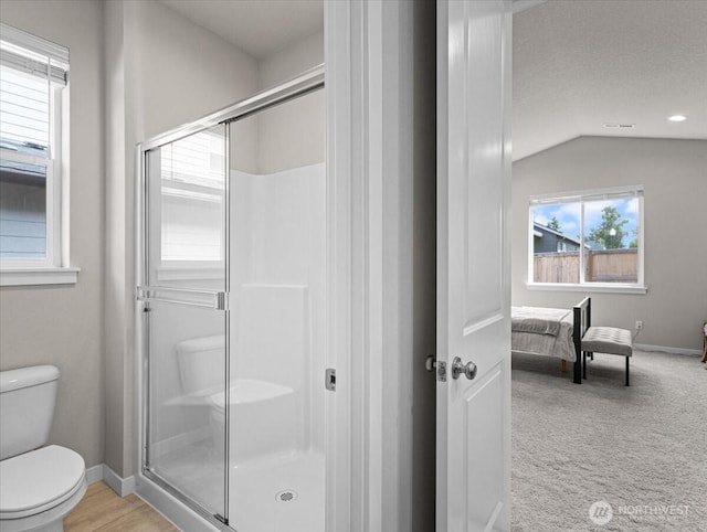4413 NE 182nd St Unit 111, Vancouver, WA 98686 - full bathroom featuring toilet, connected bathroom, vaulted ceiling, a stall shower, and baseboards