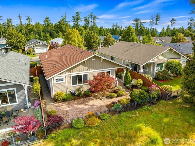8315 Vashon Dr NE, Lacey, WA 98516 - view of front of home featuring board and batten siding, a fenced backyard, a residential view, and central AC unit