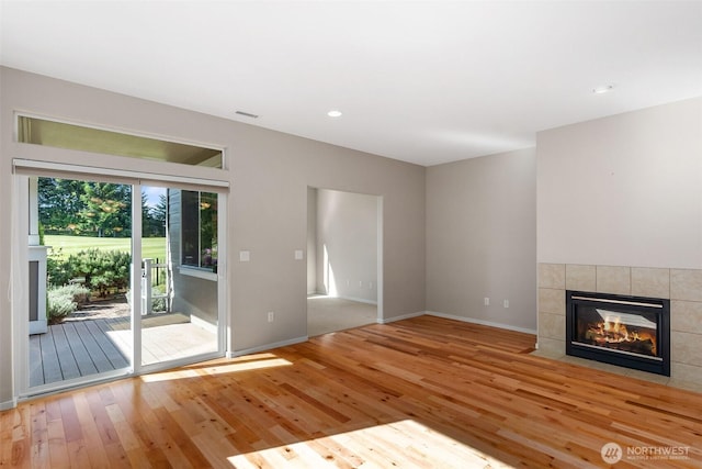 8315 Vashon Dr NE, Lacey, WA 98516 - unfurnished living room featuring a fireplace, hardwood / wood-style floors, baseboards, and recessed lighting