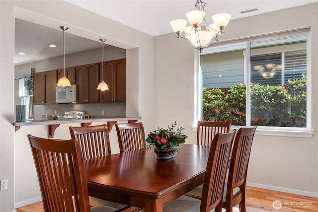 8315 Vashon Dr NE, Lacey, WA 98516 - dining area with a chandelier, light wood-style flooring, baseboards, and recessed lighting