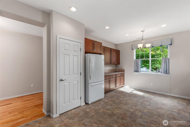 8315 Vashon Dr NE, Lacey, WA 98516 - kitchen featuring freestanding refrigerator, baseboards, a chandelier, recessed lighting, and decorative light fixtures