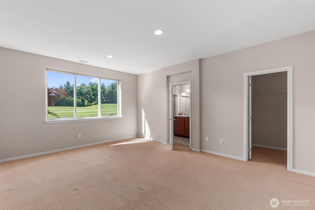 8315 Vashon Dr NE, Lacey, WA 98516 - unfurnished bedroom featuring carpet, baseboards, a spacious closet, ensuite bath, and recessed lighting