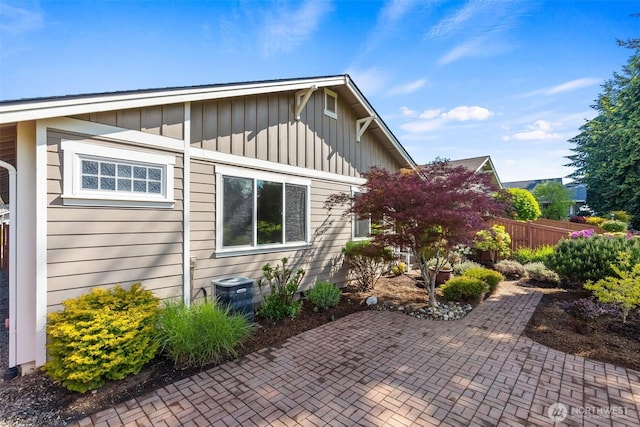 8315 Vashon Dr NE, Lacey, WA 98516 - view of home's exterior with board and batten siding, a patio area, and central air condition unit