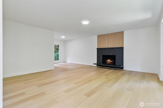 5410 240th St SW, Mountlake Terrace, WA 98043 - unfurnished living room with light wood finished floors and a brick fireplace