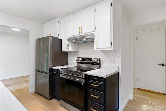 5410 240th St SW, Mountlake Terrace, WA 98043 - kitchen featuring stainless steel appliances, under cabinet range hood, white cabinetry, light countertops, and light wood finished floors