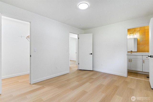 5410 240th St SW, Mountlake Terrace, WA 98043 - unfurnished bedroom featuring light wood-style flooring, a walk in closet, ensuite bathroom, and a closet