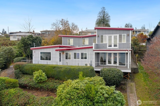 10445 Dixon Dr S, Seattle, WA 98178 - back of property featuring a balcony and board and batten siding