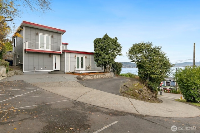 10445 Dixon Dr S, Seattle, WA 98178 - view of front of property with french doors, a balcony, and uncovered parking