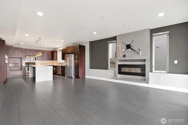10445 Dixon Dr S, Seattle, WA 98178 - unfurnished living room featuring a large fireplace, recessed lighting, baseboards, and dark wood finished floors