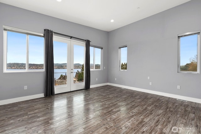 10445 Dixon Dr S, Seattle, WA 98178 - empty room featuring plenty of natural light, dark wood finished floors, baseboards, and recessed lighting