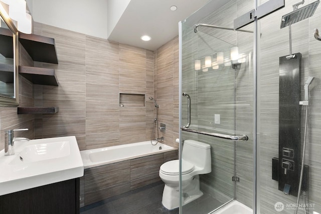 10445 Dixon Dr S, Seattle, WA 98178 - bathroom with tile walls, toilet, vanity, tiled shower / bath, and tile patterned floors