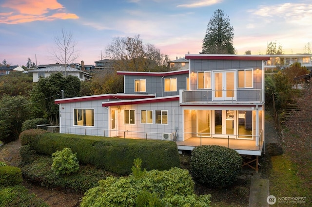 10445 Dixon Dr S, Seattle, WA 98178 - back of property at dusk with a balcony and board and batten siding