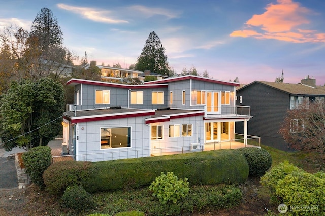 10445 Dixon Dr S, Seattle, WA 98178 - back of house at dusk featuring a balcony