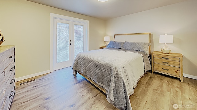 3060 NE Wheeler St, Poulsbo, WA 98370 - bedroom featuring access to exterior, light wood finished floors, and baseboards