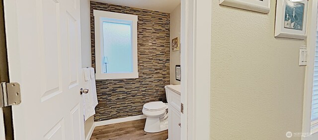 3060 NE Wheeler St, Poulsbo, WA 98370 - bathroom featuring toilet, wood finished floors, an AC wall unit, and vanity