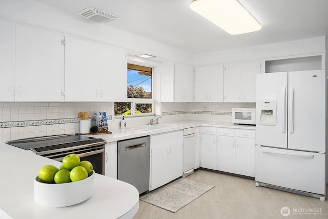 6085 Ann Arbor Ave NE, Seattle, WA 98115 - kitchen featuring stainless steel appliances, backsplash, light countertops, and white cabinetry