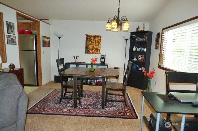 716 Dennis St SE Unit 48, Tumwater, WA 98501 - carpeted dining space with a chandelier