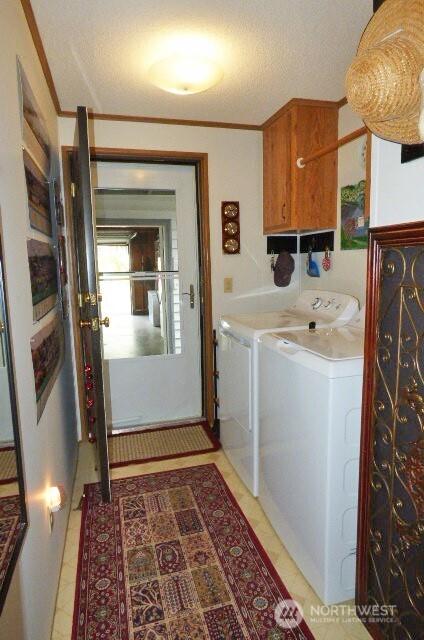 716 Dennis St SE Unit 48, Tumwater, WA 98501 - laundry room with cabinet space, washing machine and dryer, and a textured ceiling