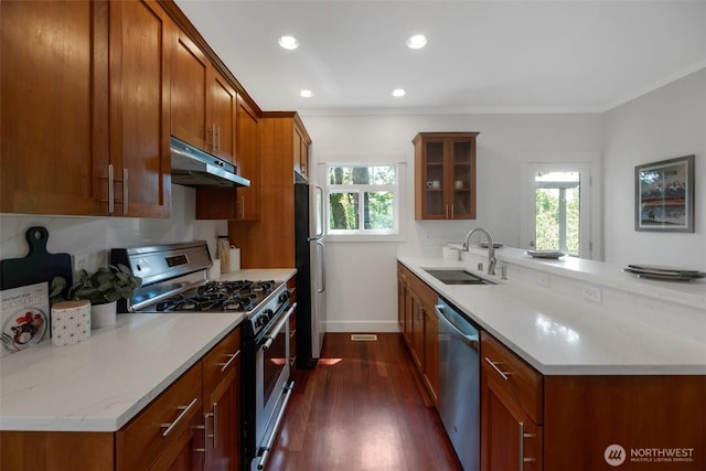 1126 24th Ave, Seattle, WA 98122 - kitchen with appliances with stainless steel finishes, a sink, under cabinet range hood, a peninsula, and brown cabinets