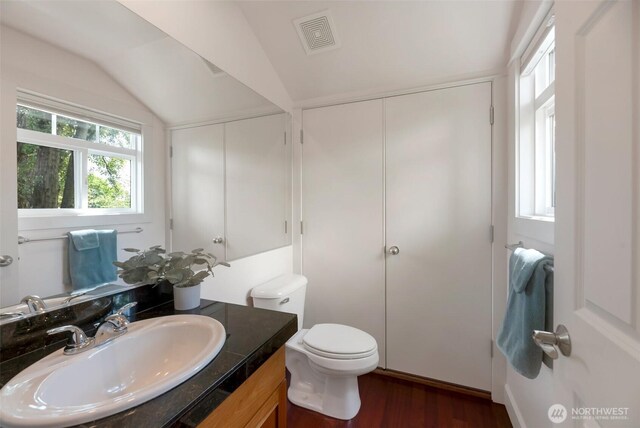 1126 24th Ave, Seattle, WA 98122 - half bathroom with lofted ceiling, vanity, wood finished floors, and toilet