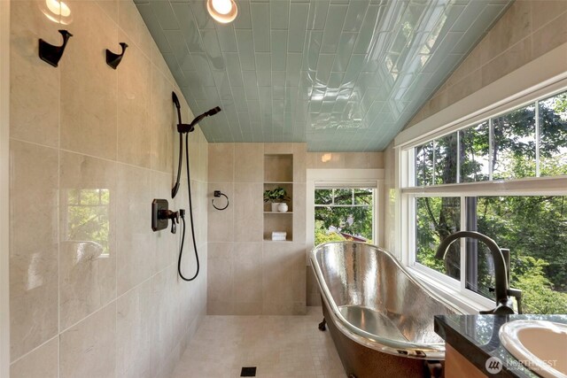 1126 24th Ave, Seattle, WA 98122 - full bathroom with a tile shower, tile walls, tile patterned flooring, vanity, and lofted ceiling