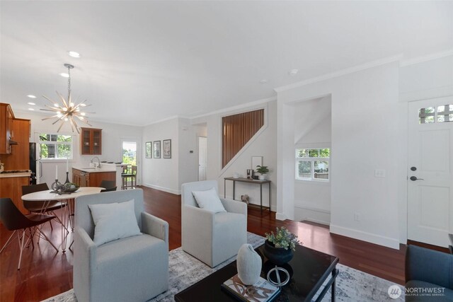 1126 24th Ave, Seattle, WA 98122 - living room featuring wood finished floors, ornamental molding, a chandelier, baseboards, and recessed lighting