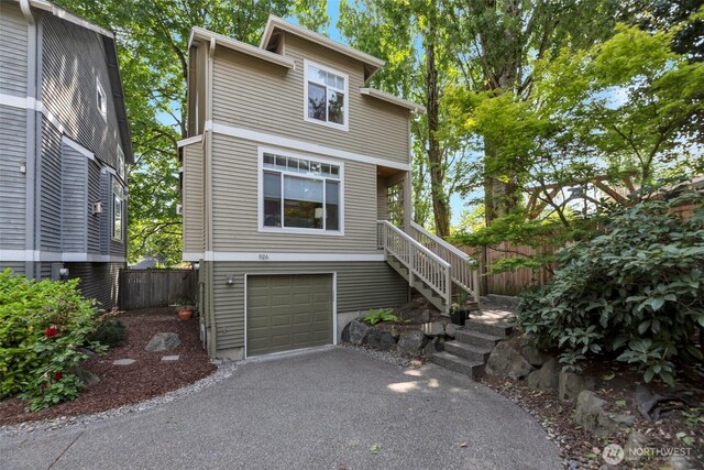 1126 24th Ave, Seattle, WA 98122 - view of front of property featuring stairway, an attached garage, and asphalt driveway