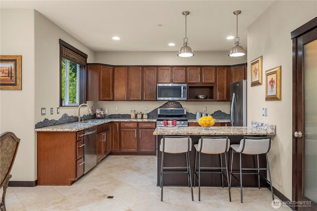 7203 Myers Rd E, Bonney Lake, WA 98391 - kitchen with stainless steel appliances, a sink, light stone countertops, a peninsula, and recessed lighting