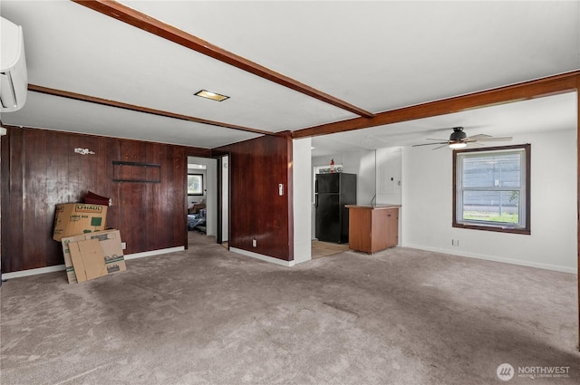 4222 S Spencer St, Seattle, WA 98118 - unfurnished living room with wooden walls, ceiling fan, carpet, beamed ceiling, and baseboards