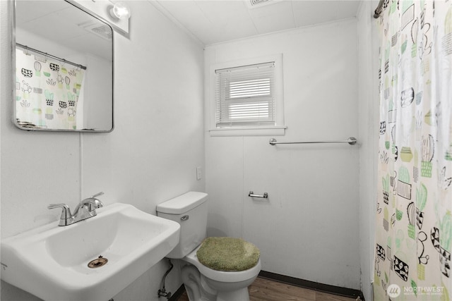 4222 S Spencer St, Seattle, WA 98118 - bathroom with toilet, a sink, and wood finished floors