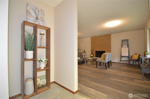 18215 108th Ave NE, Bothell, WA 98011 - foyer featuring a brick fireplace, wood finished floors, baseboards, and a textured ceiling