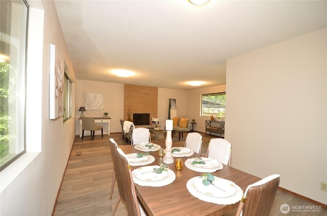 18215 108th Ave NE, Bothell, WA 98011 - dining room with light wood-style flooring and a brick fireplace