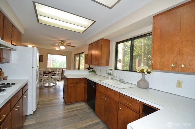 18215 108th Ave NE, Bothell, WA 98011 - kitchen with dishwasher, a sink, light countertops, brown cabinetry, and wood finished floors