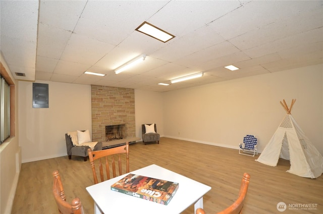 18215 108th Ave NE, Bothell, WA 98011 - rec room with wood finished floors, a fireplace, and baseboards