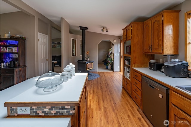 1822 W Devanny Ln, Port Angeles, WA 98363 - kitchen featuring dishwasher, a wood stove, light wood-style floors, light countertops, and brown cabinets