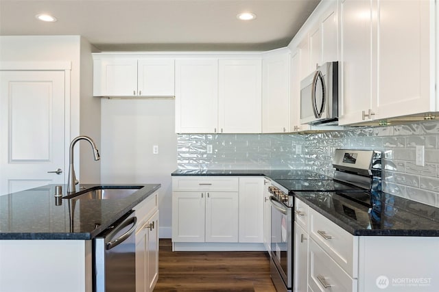 4214 W Sandy Ct, Moses Lake, WA 98837 - kitchen featuring appliances with stainless steel finishes, a sink, dark wood-type flooring, dark stone countertops, and white cabinets