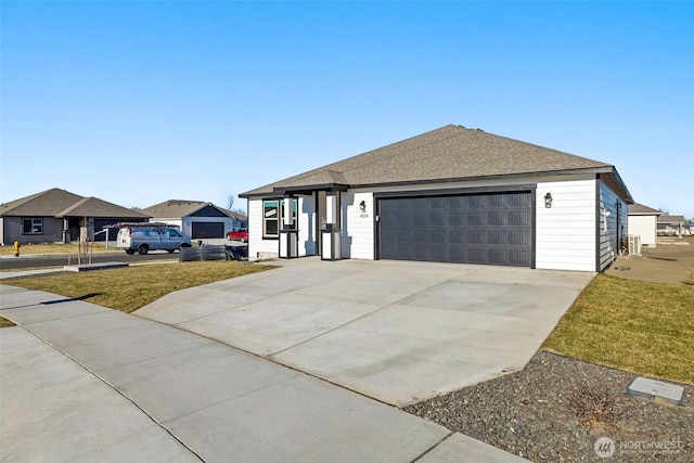 4214 W Sandy Ct, Moses Lake, WA 98837 - ranch-style home with an attached garage, a front yard, concrete driveway, and a shingled roof