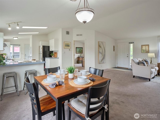 7127 Ortelius Dr, Ilwaco, WA 98624 - dining room featuring light colored carpet and healthy amount of natural light