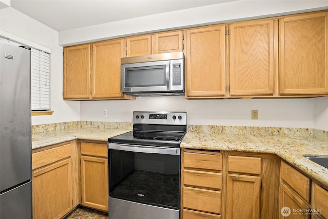 12044 96th Ave NE Unit 221, Kirkland, WA 98034 - kitchen featuring appliances with stainless steel finishes and light stone counters