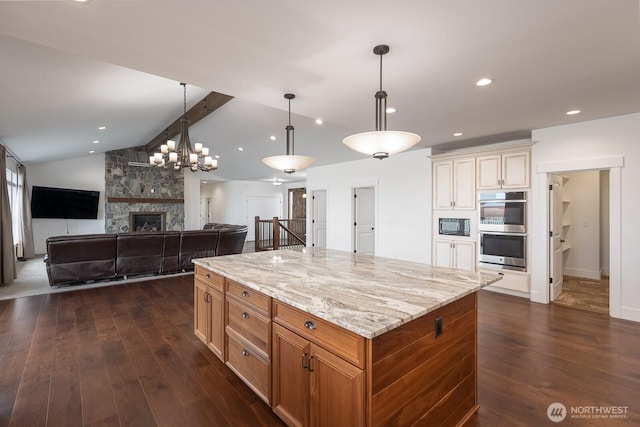 7328 Stonecrest Rd NE, Moses Lake, WA 98837 - kitchen with double oven, dark wood-type flooring, black microwave, light stone countertops, and recessed lighting