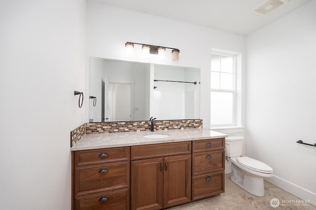 7328 Stonecrest Rd NE, Moses Lake, WA 98837 - full bath with backsplash, vanity, toilet, baseboards, and a shower