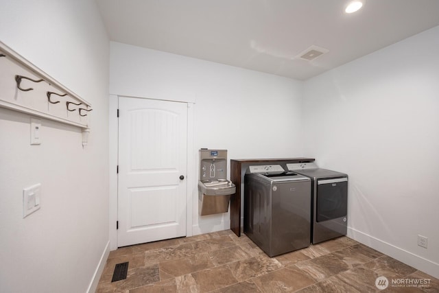 7328 Stonecrest Rd NE, Moses Lake, WA 98837 - washroom featuring washer and dryer, baseboards, and stone finish flooring