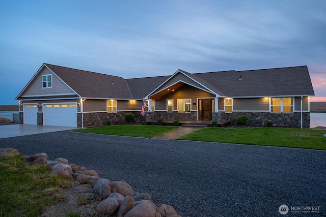 7328 Stonecrest Rd NE, Moses Lake, WA 98837 - craftsman house with stone siding, a yard, an attached garage, and concrete driveway