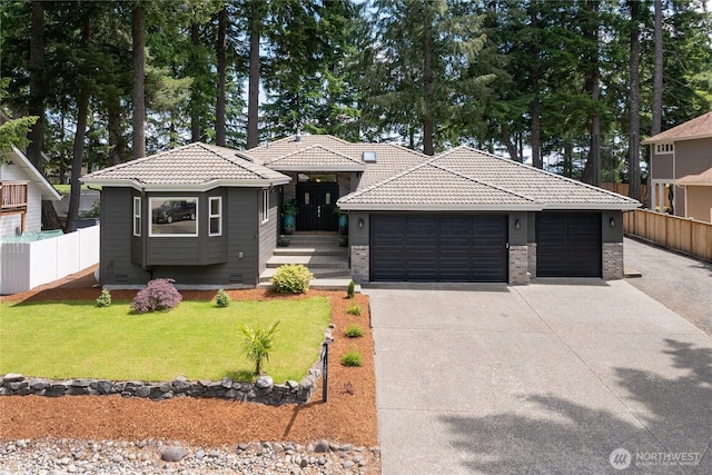1361 E Old Ranch Rd, Allyn, WA 98524 - view of front of house featuring a tiled roof, a garage, concrete driveway, and brick siding