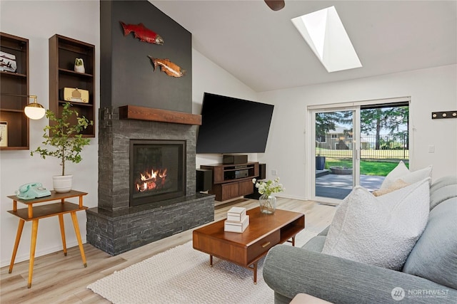 1361 E Old Ranch Rd, Allyn, WA 98524 - living room with a skylight, wood finished floors, a fireplace, lofted ceiling, and baseboards