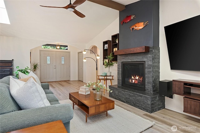 1361 E Old Ranch Rd, Allyn, WA 98524 - living area featuring arched walkways, a ceiling fan, wood finished floors, and a fireplace